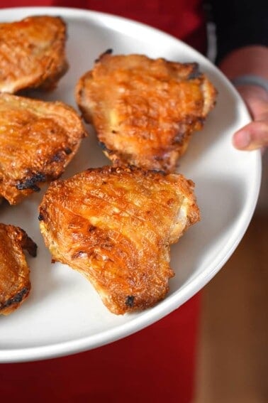 A close up shot of Umami Roast Chicken on a white platter