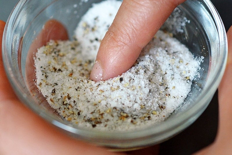 Closeup of a small ramekin filled with salt and pepper to season weeknight roast chicken