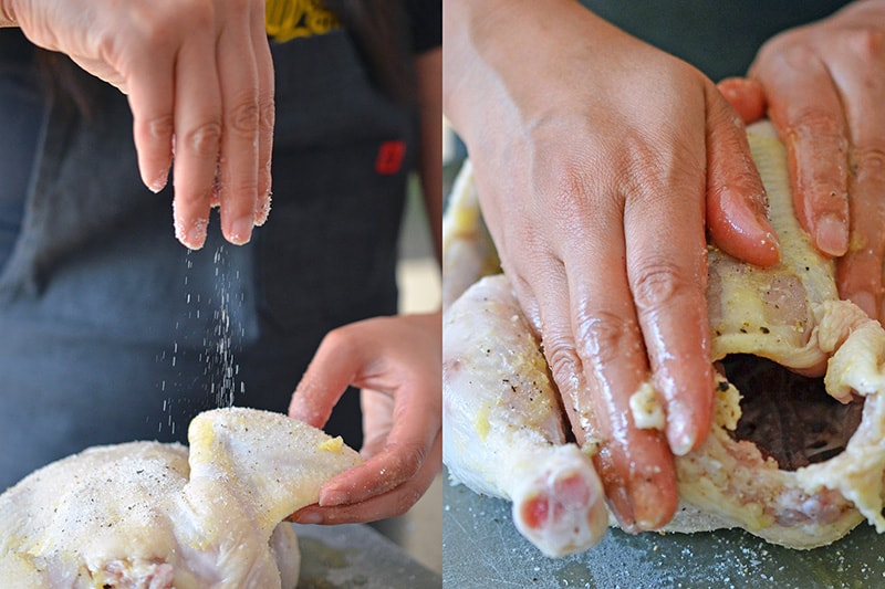 Sprinkling salt and pepper all over a raw whole chicken to make weeknight roast chicken