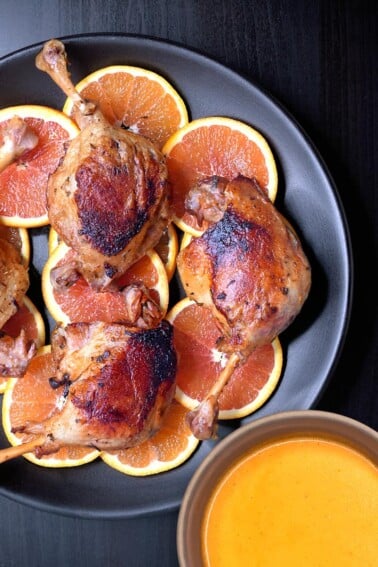An overhead shot of Instant Pot crispy orange duck legs and gravy.
