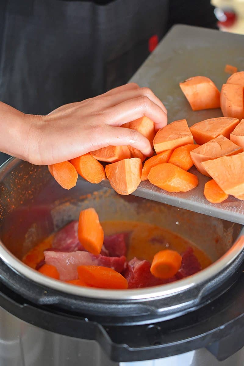 Cubed sweet potato is added to the Instant Pot 