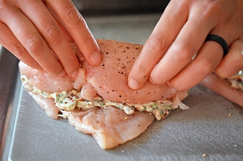 The chicken breast is carefully rolled around the seasoned mayonnaise filling.