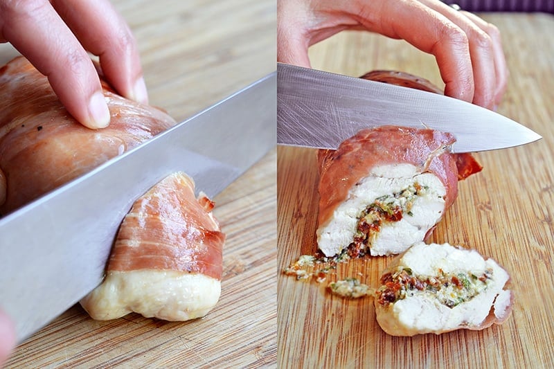 Chicken Prosciutto Involtini is sliced on a wooden cutting board.
