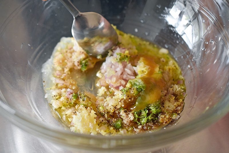 Stirring the Vietnamese Lemongrass Chicken marinade in a large bowl.