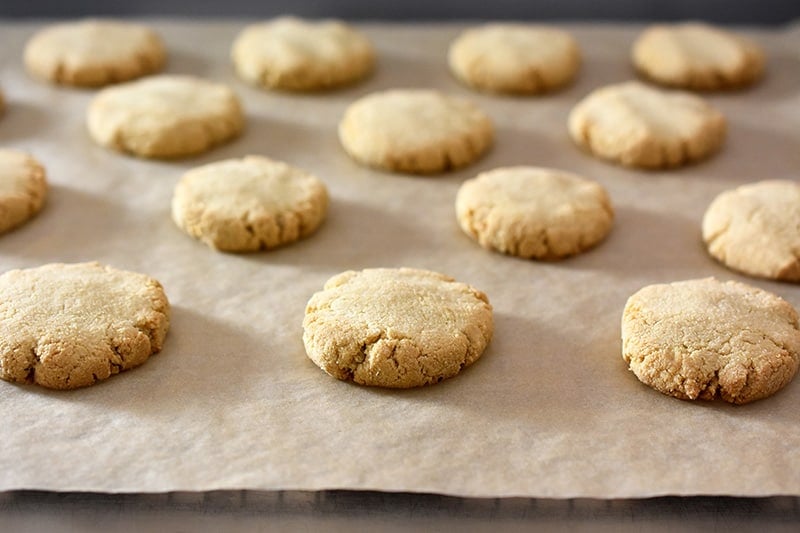 A shot of freshly baked The World's Easiest Cookies on a sheet of parchment paper.