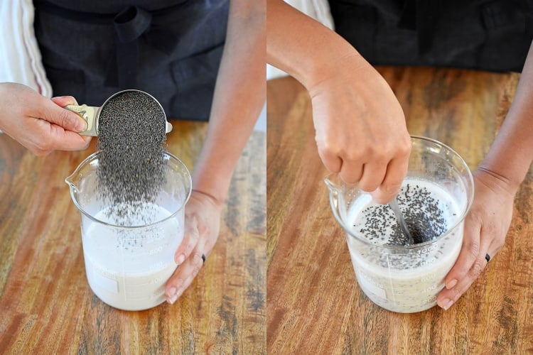 Someone is pouring chia seeds into the blended milk mixture and mixing it.