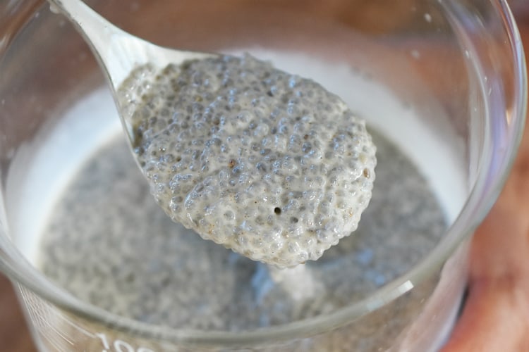 A spoon full of the thickened chia seed and milk mixture.