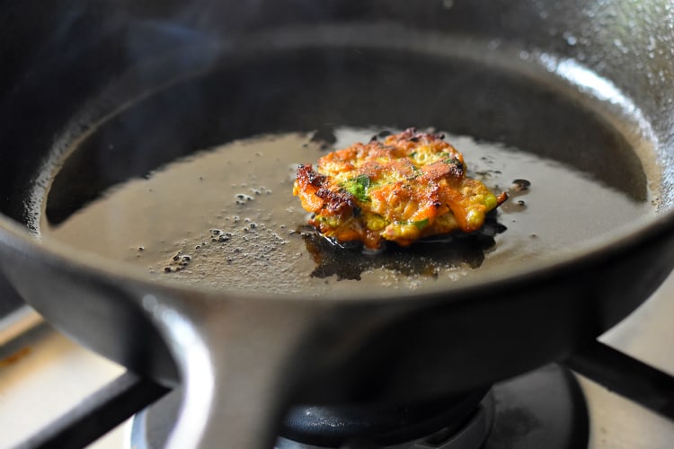 Frying a small tester Curry Turkey Bites in a cast iron skillet to taste for seasoning.