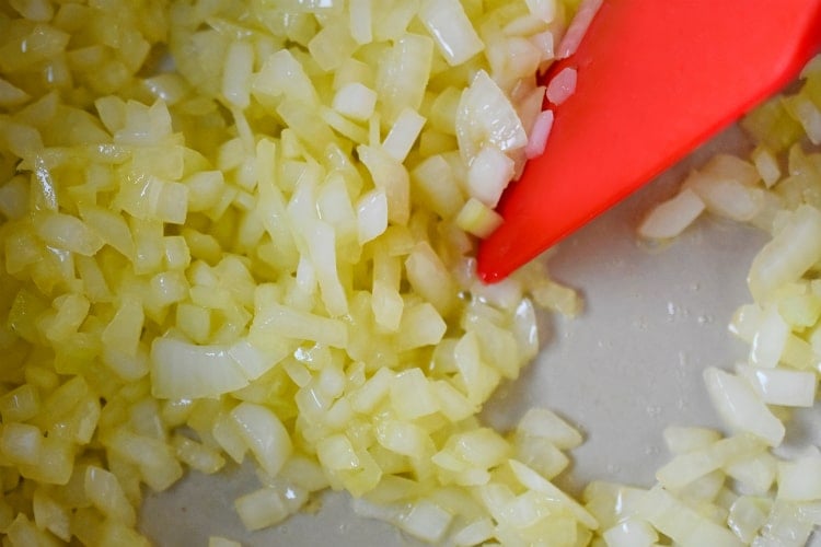 Sautéing diced onions until they are soft. 