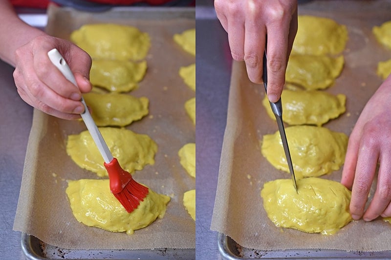 Brushing an egg wash on Paleo Curried Meat Pies and then cutting slits on top with a paring knife