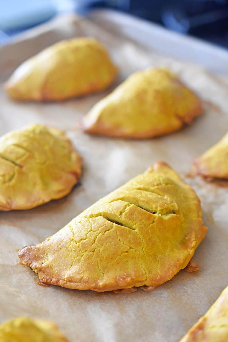 A closeup of golden brown Paleo Curried Meat Pies fresh from the oven.