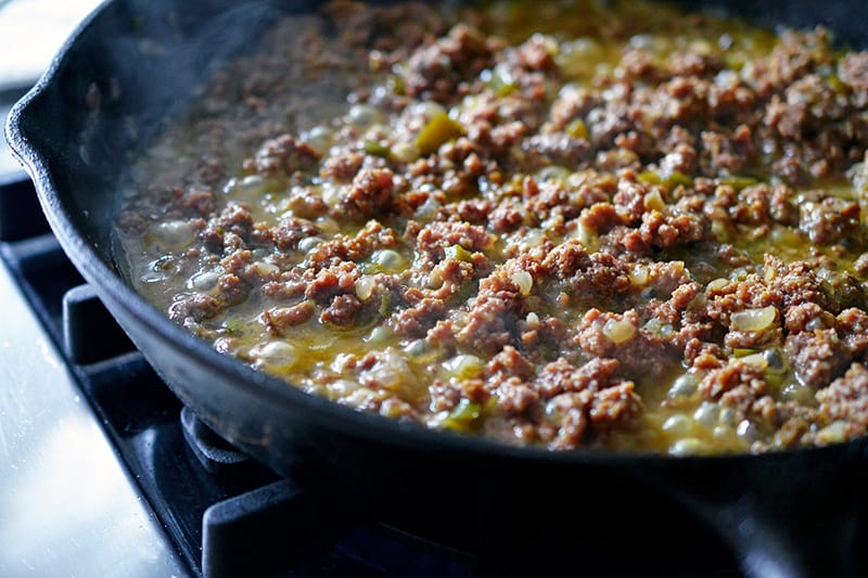 The meat for deconstructed samosa simmering off in a pan.