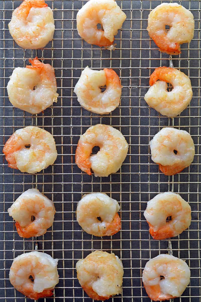 Paleo Walnut Shrimp on a wire rack waiting to be tossed in the creamy dressing.
