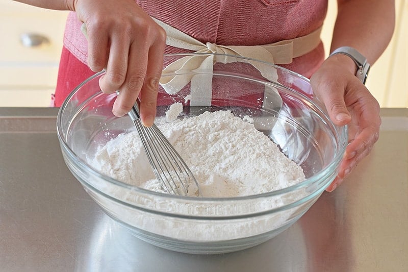 Whisking the dry ingredients in a glass bowl to make nut-free, gluten-free, Paleo Scallion Pancakes 