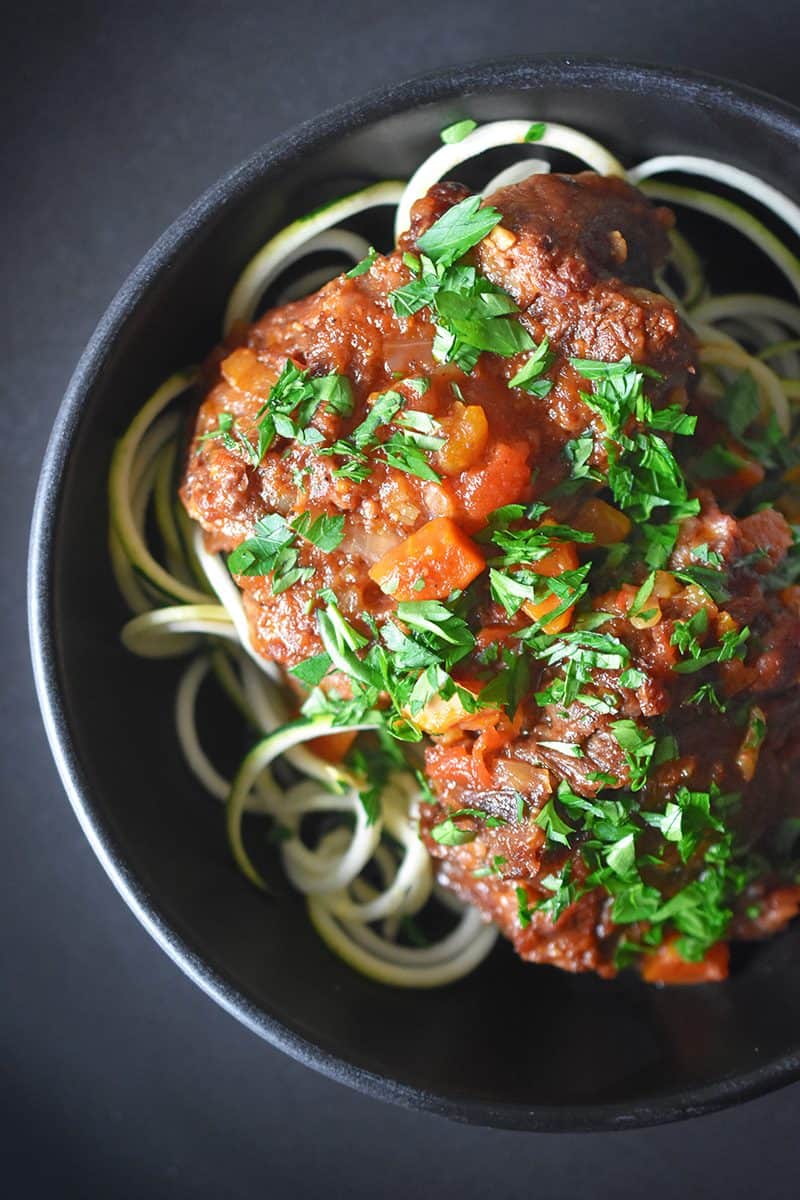 An overhead shot of Instant Pot Oxtail Stew on a bed of zucchini noodles.