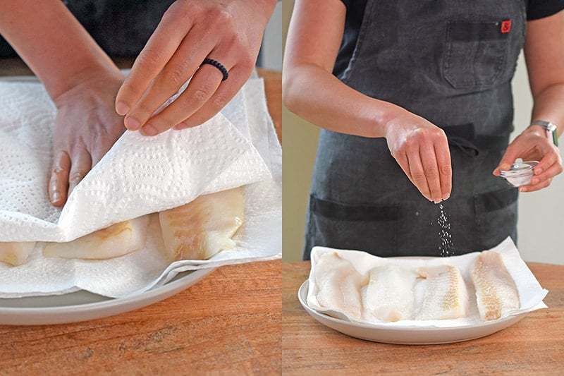 Patting dry cod filets with paper towels and sprinkling salt on the fish.