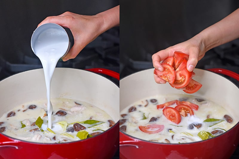 Adding coconut milk and tomato slices to a pot of home cooked paleo Tom Kha Gai 
