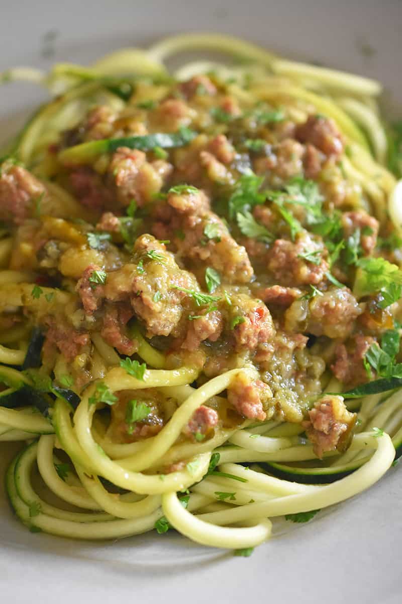 A closeup shot of Instant Pot Zucchini Bolognese on top of zucchini noodles.