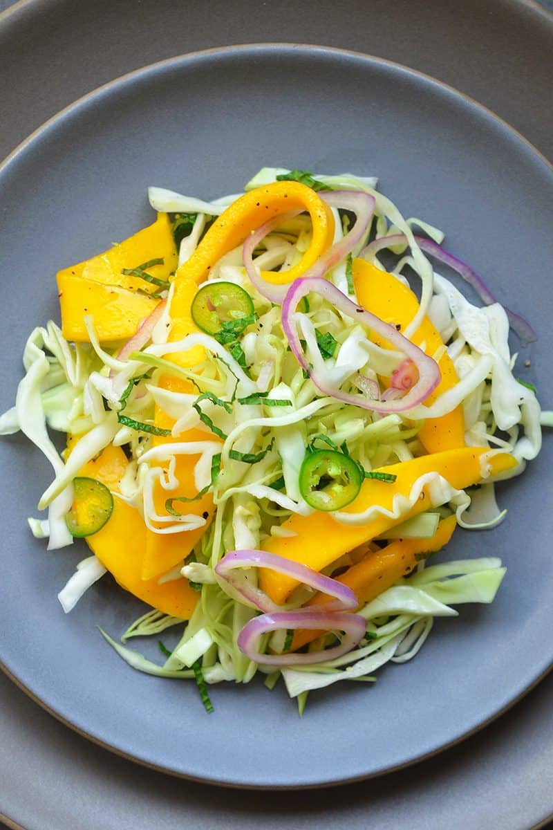 Overhead shot of paleo spicy mango cabbage slaw on a plate.