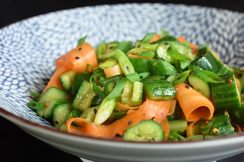 Close up of the paleo and whole30 smashed cucumber and carrot salad in a bowl.