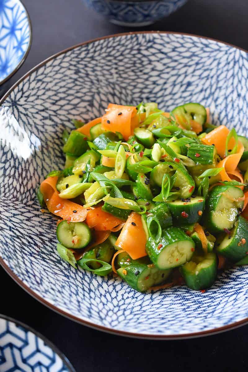 A close up of the paleo and whole30 smashed cucumber and carrot salad recipe in a bowl.