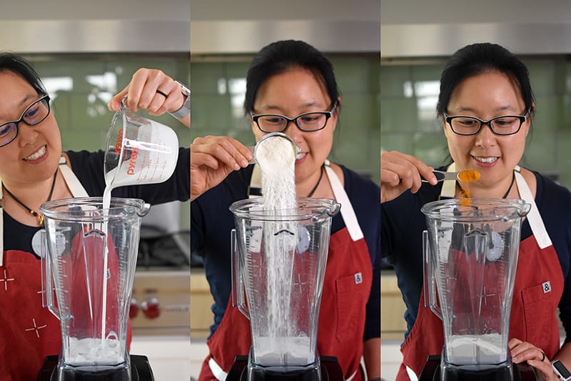 Michelle Tam adding the ingredients of coconut milk, turmeric, and collagen peptides for Golden Glow Smoothie into a Vitamix blender.