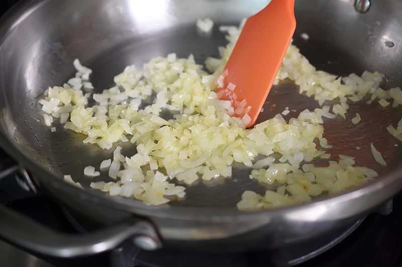 Cooking the onions until they are slightly softened for healthy Mexican Cauliflower rice