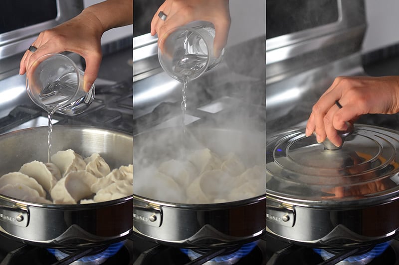 A small amount of boiling water is being poured into the pan and then a lid is placed over the Paleo Pot Stickers.