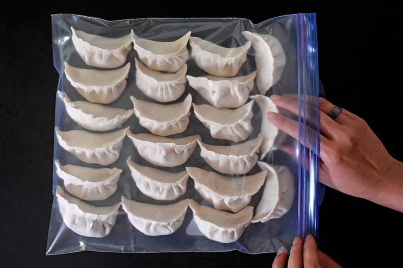 Paleo Pot Stickers carefully lined up in a single layer in a Ziplock freezer bag.