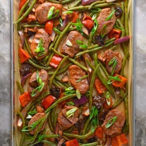An overhead shot of Sheet Pan Sweet and Spicy Pork on a marble countertop.