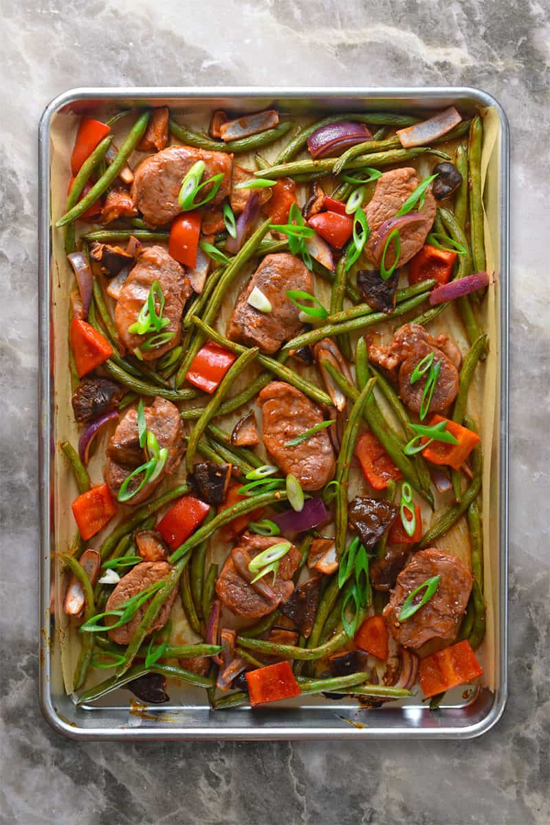 An overhead shot of Sheet Pan Sweet and Spicy Pork on a marble countertop.