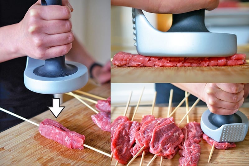 A meat pounder is used to flatten the steak skewers.