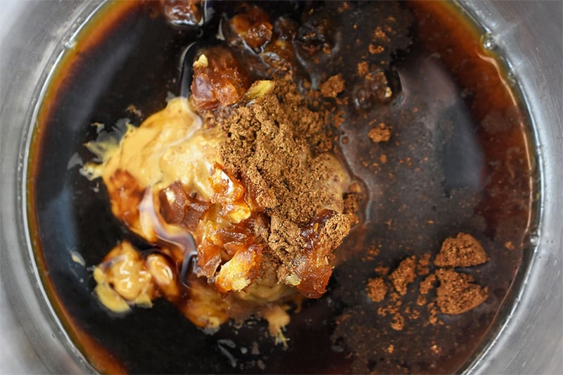 An overhead shot of the ingredients of paleo hoisin sauce in a saucepan before it gets cooked.
