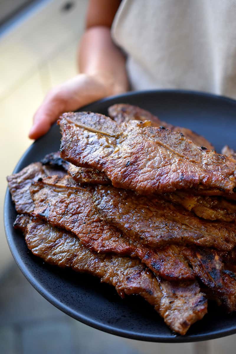 A platter filled with paleo galbi cooked in the oven.