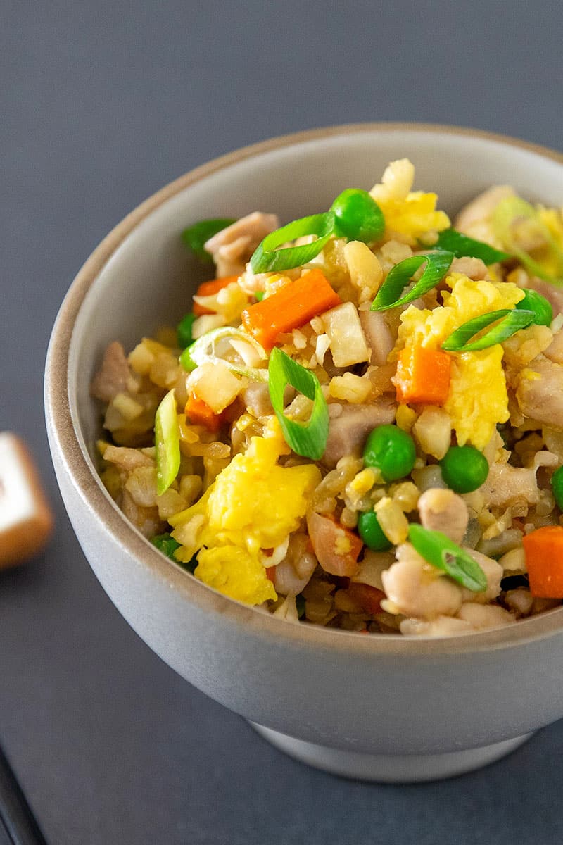 Close up shot of Cauliflower Chicken Fried Rice, a Whole30-friendly and healthy one-pan dinner.