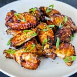 A white plate filled with Whole30, gluten-free, paleo Chinese Chicken Wings, a super easy game day appetizer!