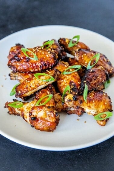 A white plate filled with Whole30, gluten-free, paleo Chinese Chicken Wings, a super easy game day appetizer!