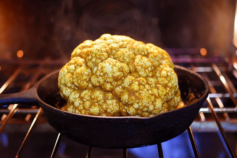 Tandoori Whole Roasted Cauliflower baking uncovered in the oven.