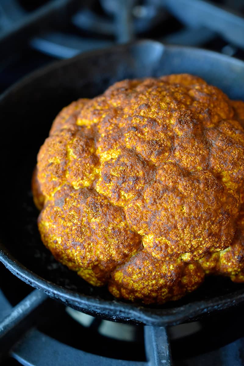 An overhead shot of Tandoori Whole Roasted Cauliflower golden brown and ready to serve.