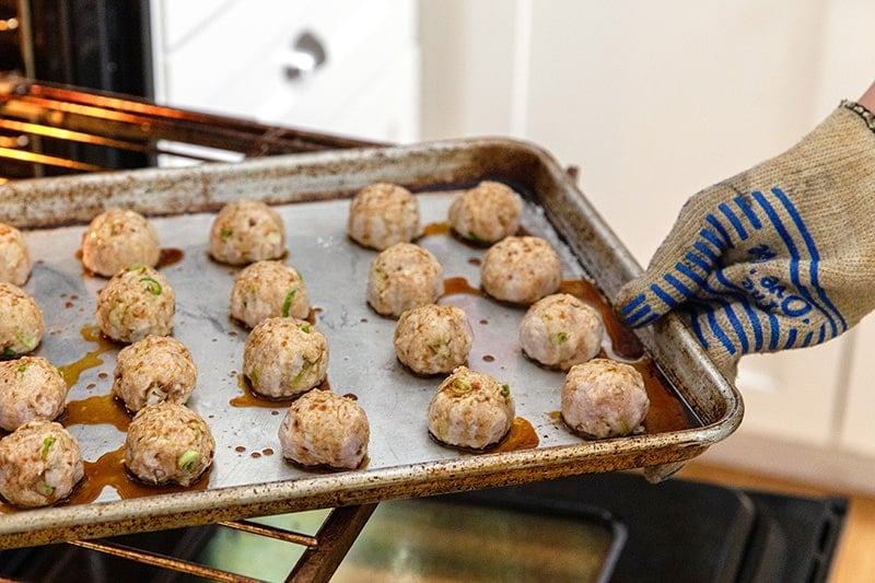 Rotating a tray of Whole30 tsukune, Japanese ground chicken meatballs.