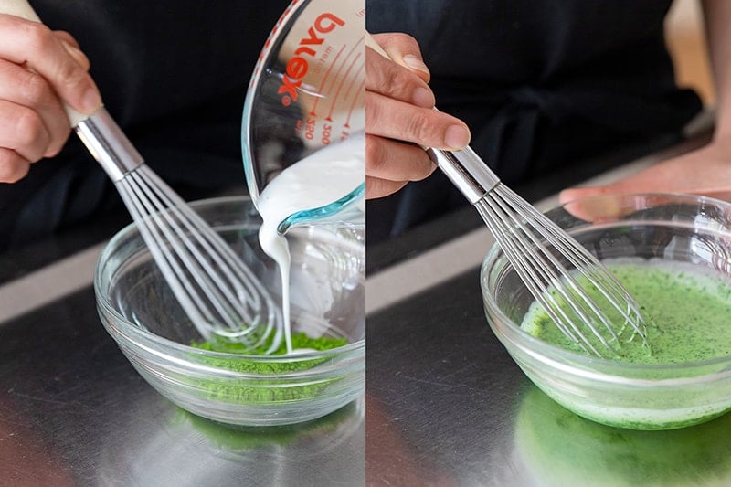 Pouring coconut milk into the bowl with the matcha and stirring it with a whisk.