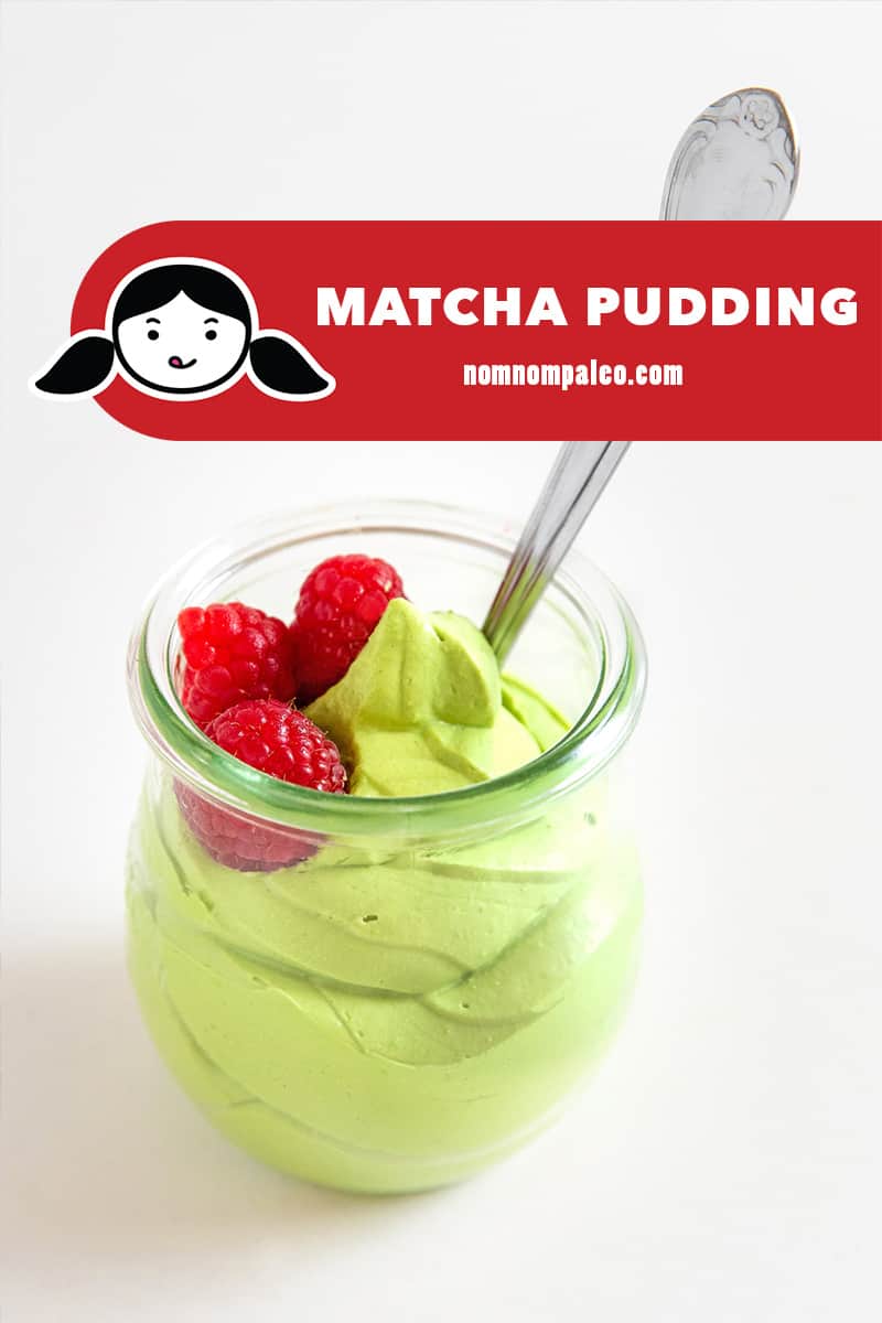 A closeup shot of paleo matcha pudding in a clear glass, topped with fresh raspberries.