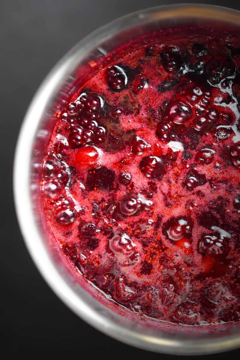 An overhead shot of paleo cranberry sauce simmering in a saucepan
