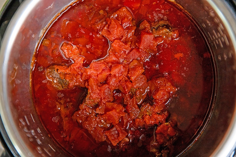 An overhead shot of an open Instant Pot filled with a tomato meat sauce