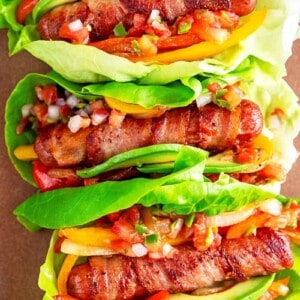 An overhead shot of Whole30, keto, and paleo Sonoran hot dogs wrapped in lettuce and topped with salsa.