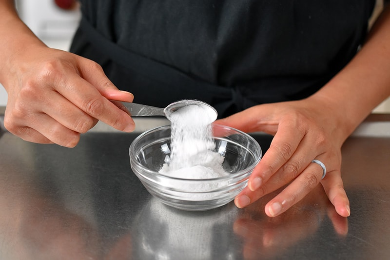 Adding the ingredients for grain-free and paleo baking powder in a small bowl.