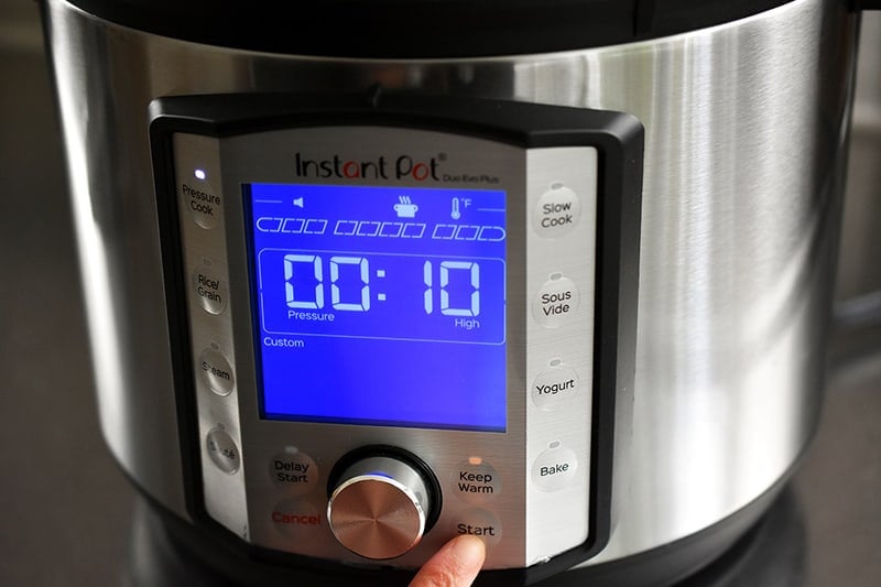 The front display of an Instant Pot Duo Evo Plus the says 10 minutes and high pressure