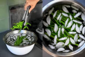 A pair of tongs is transferring cooked asparagus to a bowl of ice water.