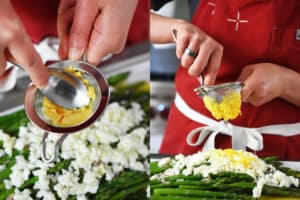 Someone pushing cooked egg yolks though a small metal sieve on top of asparagus to make asparagus mimosa.