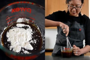 A smiling Asian woman is whisking All-Purpose Stir-Fry Sauce with other seasonings in a 2 cup Pyrex measuring cup